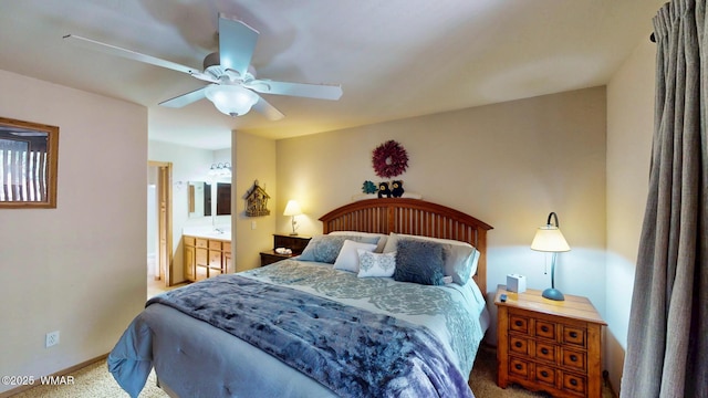 carpeted bedroom with connected bathroom, baseboards, and a ceiling fan