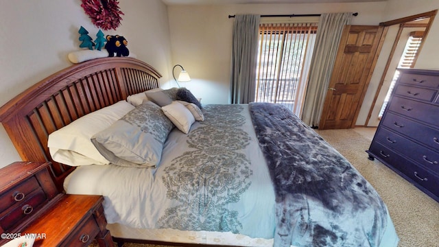 bedroom featuring light colored carpet