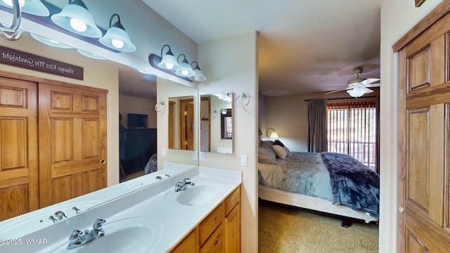 full bath with double vanity, ensuite bathroom, ceiling fan, and a sink