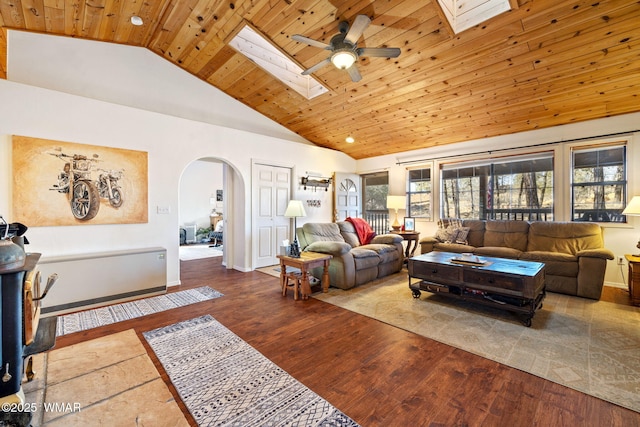 4584 Cub Lake Rd, Show Low, AZ 85901 - living room featuring a skylight, arched walkways, a ceiling fan, wooden ceiling, and wood finished floors