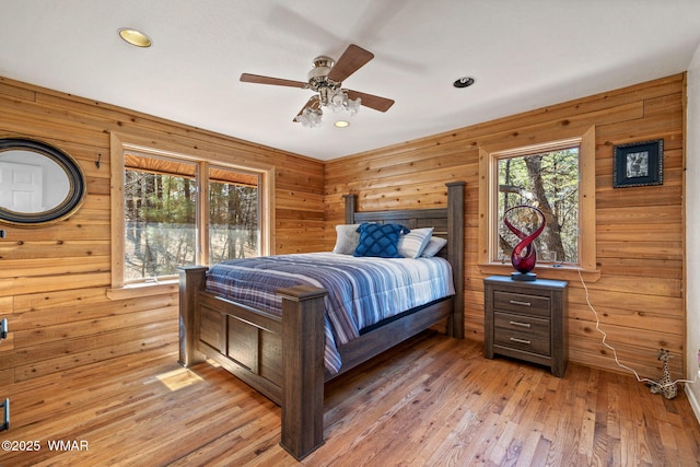 1825 E Woodchuck Ln, Pinetop, AZ 85935 - bedroom with light wood-style floors, wooden walls, and a ceiling fan