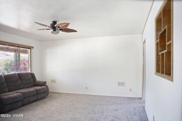 living area featuring ceiling fan, carpet, and visible vents