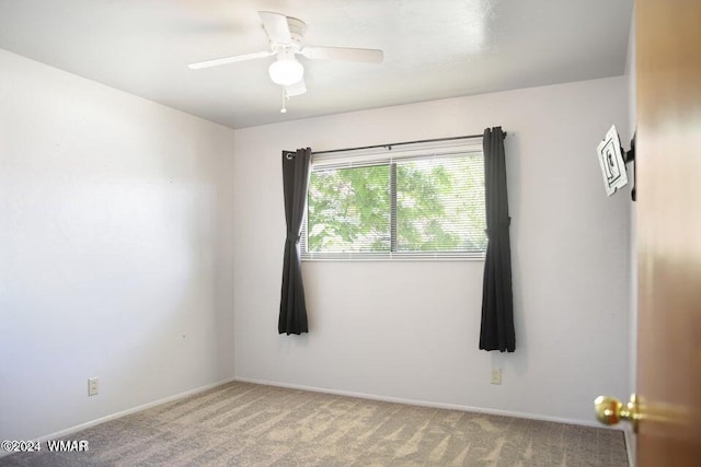 unfurnished room with ceiling fan, baseboards, and carpet flooring