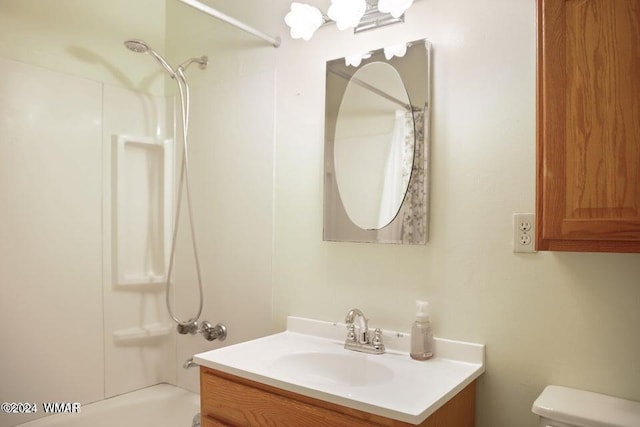 bathroom featuring  shower combination, toilet, a chandelier, and vanity