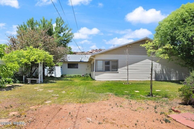 back of property featuring a yard