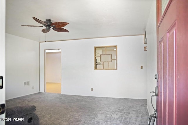 interior space with carpet, visible vents, and ceiling fan