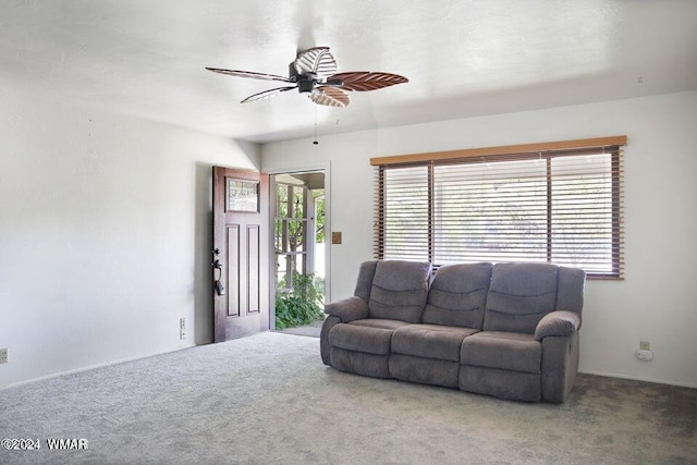 living room featuring a ceiling fan, a wealth of natural light, and carpet flooring