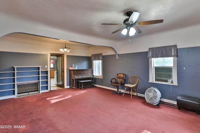 219 W Elm St, Winslow, AZ 86047 - living area with healthy amount of natural light, carpet, a ceiling fan, and a chandelier