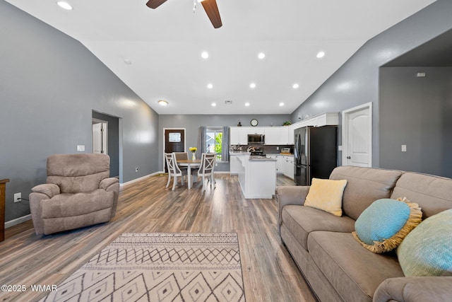 289 N Divot Dr, Eagar, AZ 85925 - living room featuring high vaulted ceiling, light wood finished floors, a ceiling fan, and recessed lighting