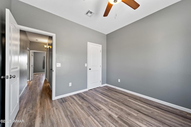 289 N Divot Dr, Eagar, AZ 85925 - unfurnished bedroom featuring wood finished floors and a ceiling fan