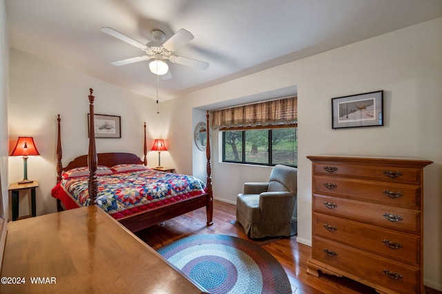 bedroom with wood finished floors, a ceiling fan, and baseboards