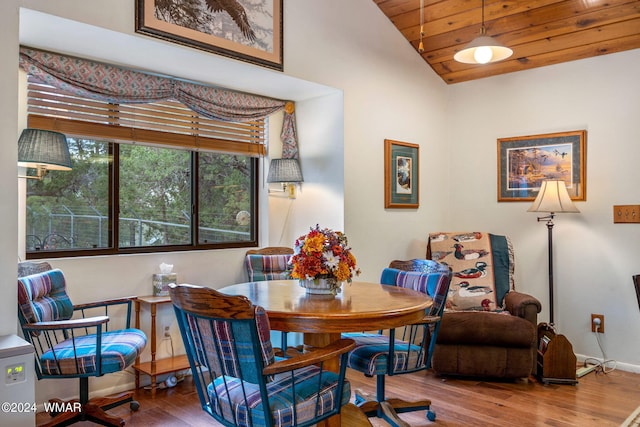 dining area featuring lofted ceiling, wood finished floors, wood ceiling, and baseboards