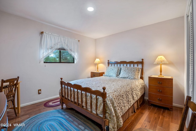 bedroom with recessed lighting, wood finished floors, and baseboards