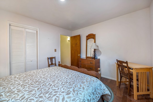 bedroom with a closet and dark wood-style flooring