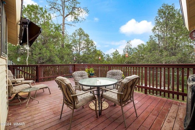 wooden terrace with outdoor dining space