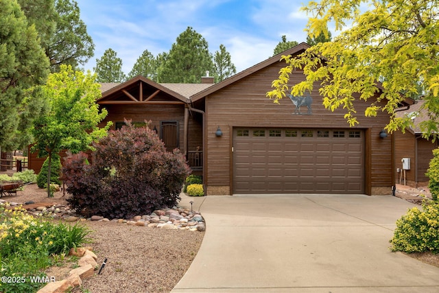 380 N Retreat Dr, Show Low, AZ 85901 - view of front of home with a chimney, concrete driveway, and a garage