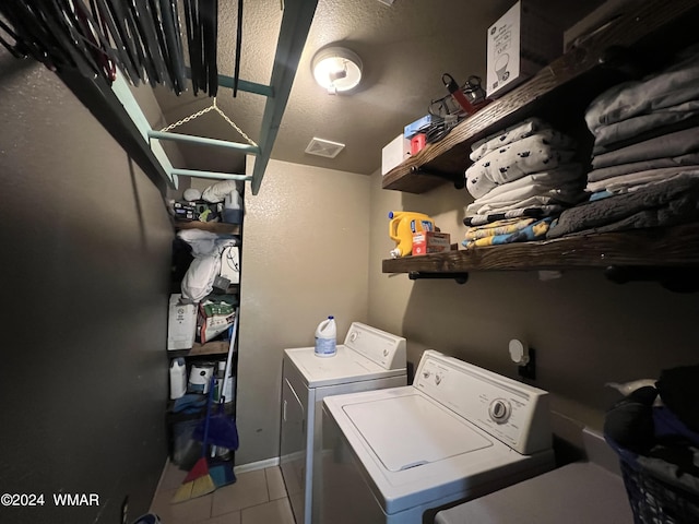 laundry area featuring light tile patterned floors, laundry area, separate washer and dryer, and visible vents
