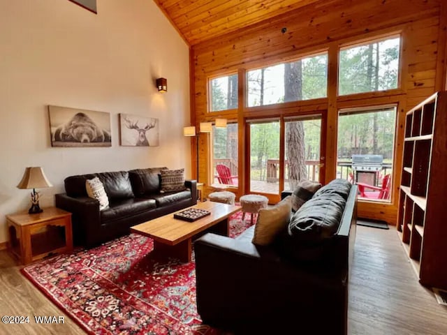 living room featuring high vaulted ceiling, wooden ceiling, and wood finished floors