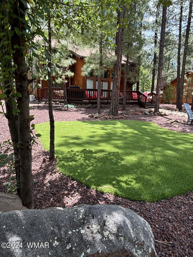 view of yard featuring a wooden deck