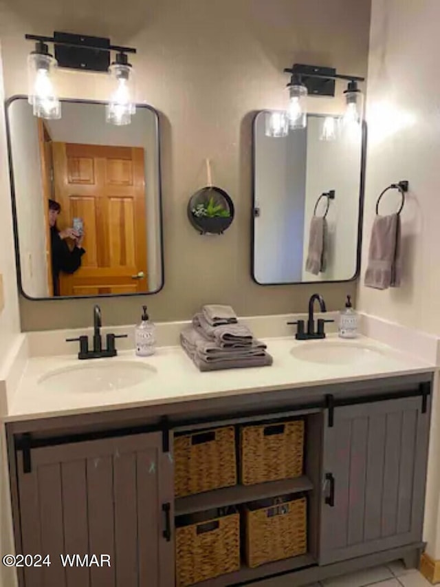 bathroom featuring double vanity, a sink, and tile patterned floors