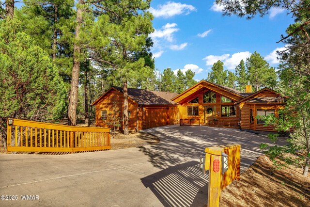 1430 E Pine Oaks Dr, Show Low, AZ 85901 - chalet / cabin featuring log veneer siding, concrete driveway, and a chimney