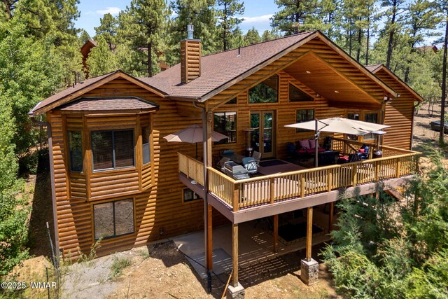 1430 E Pine Oaks Dr, Show Low, AZ 85901 - rear view of house with roof with shingles, log veneer siding, a chimney, a deck, and french doors