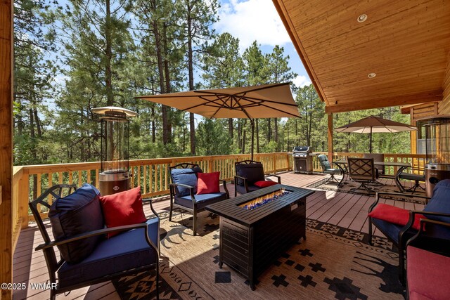 1430 E Pine Oaks Dr, Show Low, AZ 85901 - deck with an outdoor living space with a fire pit, area for grilling, outdoor dining space, and view of scattered trees