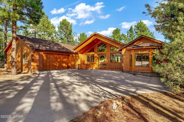 1430 E Pine Oaks Dr, Show Low, AZ 85901 - rustic home with log veneer siding, an attached garage, concrete driveway, and a shingled roof