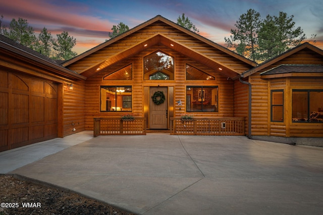 1430 E Pine Oaks Dr, Show Low, AZ 85901 - chalet / cabin with faux log siding, an attached garage, driveway, and covered porch