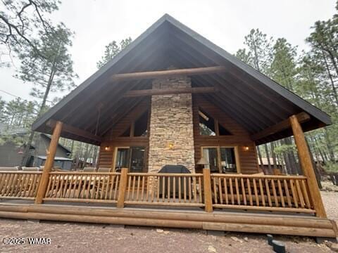exterior space with a deck and stone siding