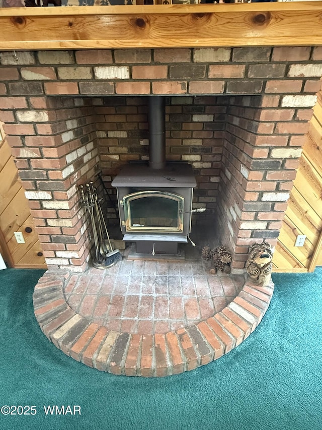 room details with a wood stove and carpet