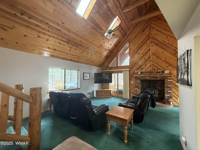 carpeted living area with wooden ceiling, wood walls, a brick fireplace, visible vents, and high vaulted ceiling