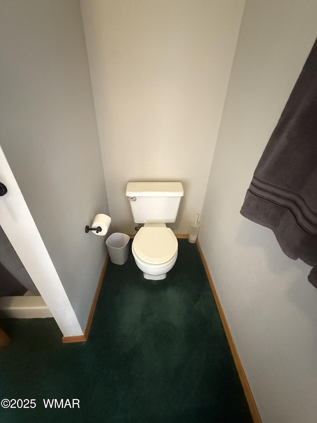 bathroom with baseboards and toilet
