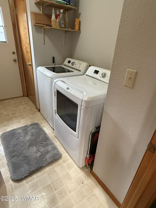 laundry room featuring washing machine and clothes dryer, laundry area, and light floors