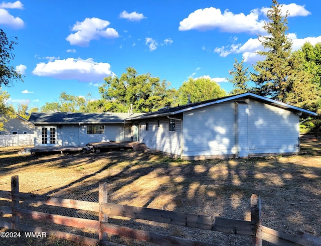 exterior space with fence and a wooden deck