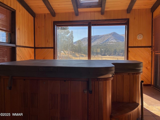 room details with wood ceiling, beam ceiling, a mountain view, and wooden walls