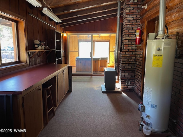 interior space with vaulted ceiling with beams, gas water heater, light carpet, and wooden walls