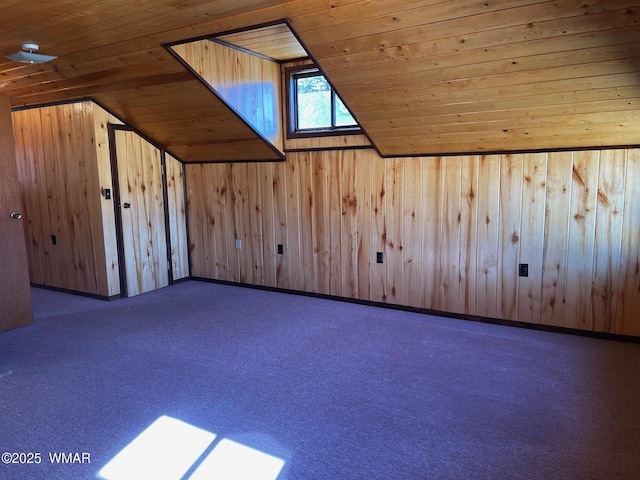 bonus room with carpet floors, wood ceiling, vaulted ceiling, and wood walls