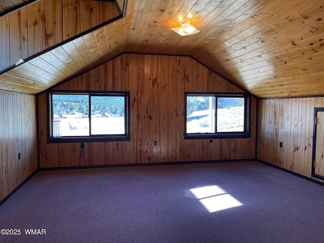 bonus room featuring wood ceiling, plenty of natural light, dark carpet, and vaulted ceiling