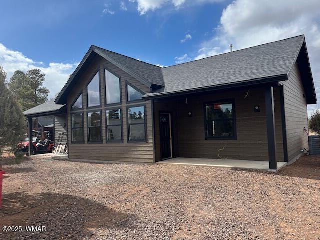 2730 Church Ln, Overgaard, AZ 85933 - back of property featuring a shingled roof and a patio