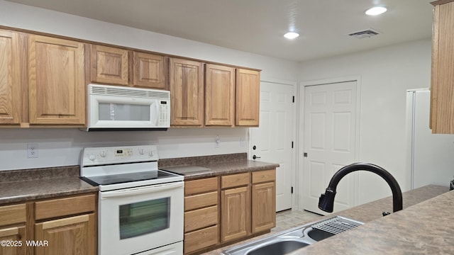 3024 Buck Crossing Way, Pinetop, AZ 85935 - kitchen with white appliances, dark countertops, recessed lighting, a sink, and brown cabinetry
