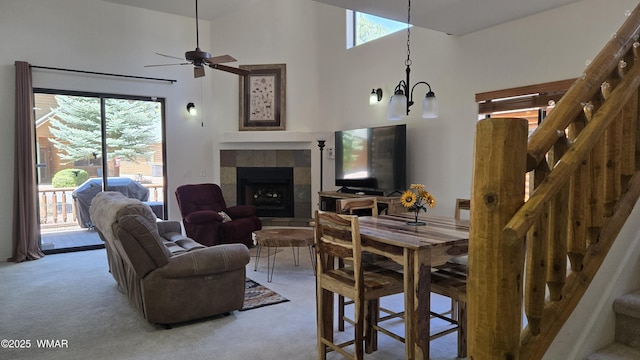 3024 Buck Crossing Way, Pinetop, AZ 85935 - living room with stairway, light carpet, a fireplace, ceiling fan, and a high ceiling