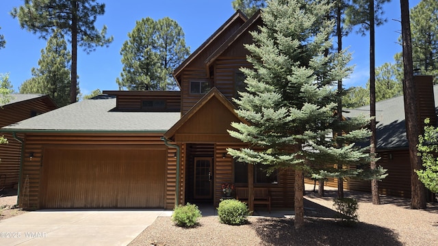 3024 Buck Crossing Way, Pinetop, AZ 85935 - log home featuring a garage, concrete driveway, and a shingled roof