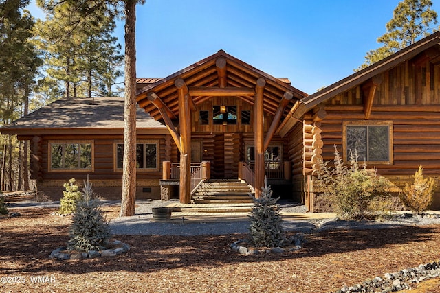 view of front of home featuring crawl space and log siding