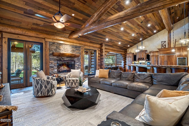 living area featuring high vaulted ceiling, a wealth of natural light, wooden ceiling, and french doors