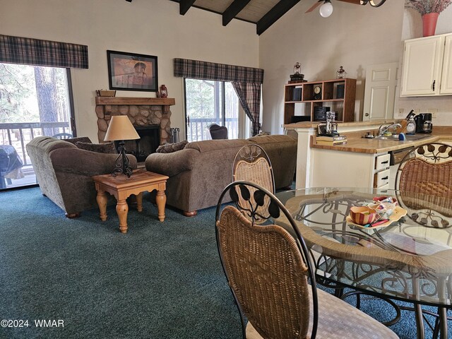 2844 Park Cir Unit 36A, Pinetop, AZ 85935 - living area featuring a stone fireplace, high vaulted ceiling, carpet flooring, and beamed ceiling
