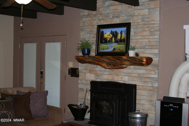 living room with ceiling fan and a fireplace