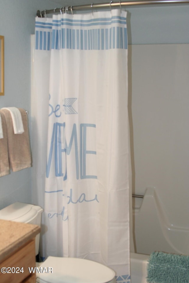 bathroom featuring toilet, shower / bathtub combination with curtain, and vanity