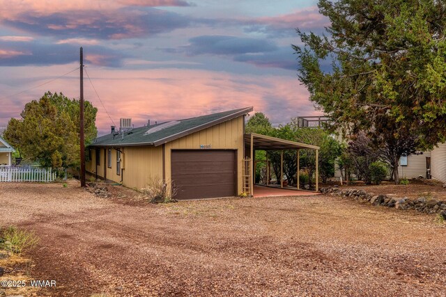 2045 Silver Creek Dr, Show Low, AZ 85901 - garage at dusk with dirt driveway and a garage