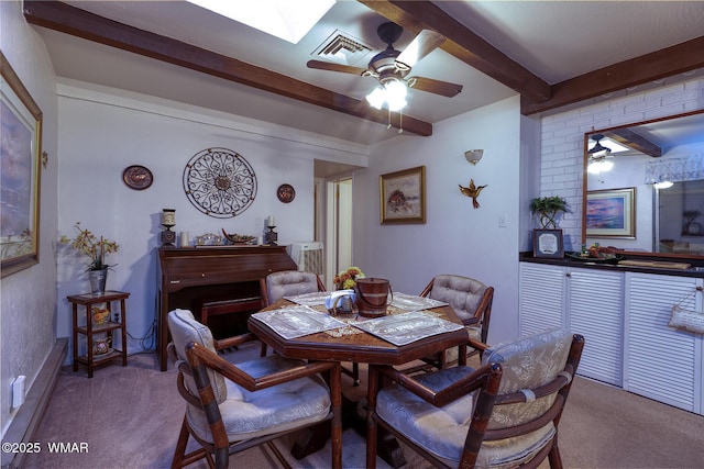 2045 Silver Creek Dr, Show Low, AZ 85901 - carpeted dining area featuring beamed ceiling, a ceiling fan, and a skylight
